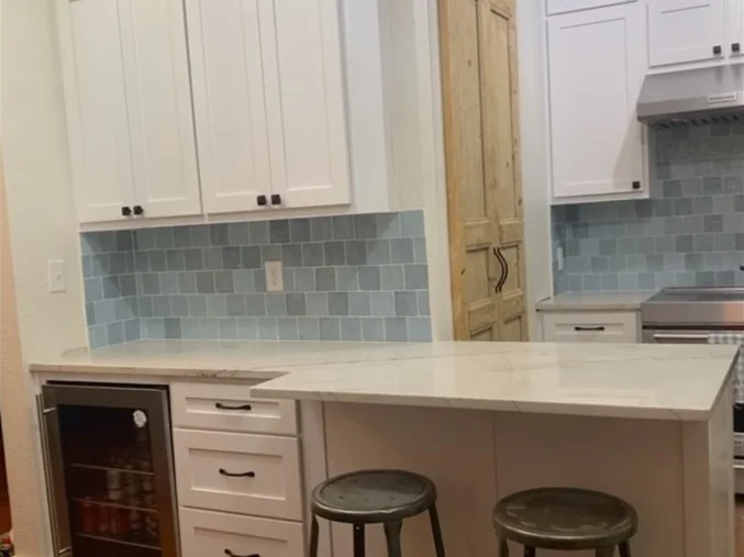 Kitchen remodel — Shaker cabinets run to the ceiling, tiled backsplash, stone island