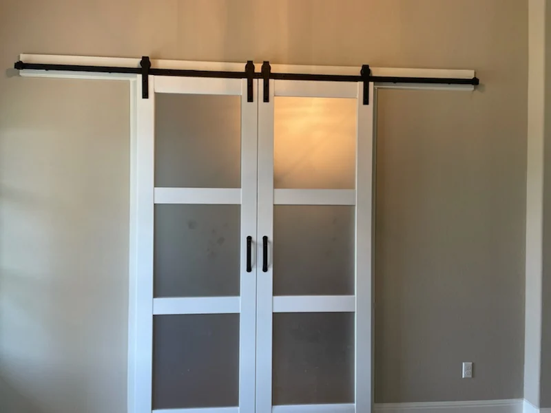 Barn doors — Hung on black track across an opening