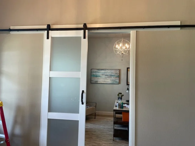 The same doors, open — Rolled clear of the living room