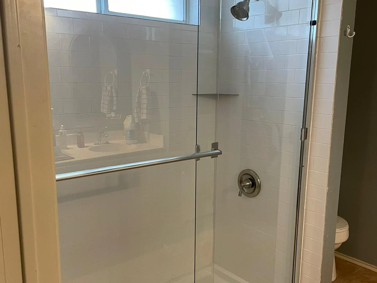 Shower — Framed sliding glass fitted to a tiled surround